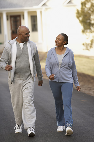 Older couple walking down a street.