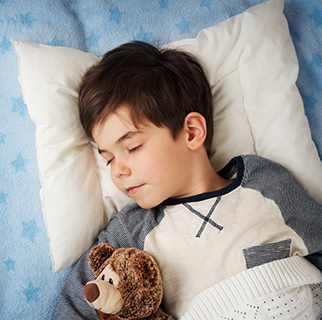 Child sleeping in his bed.